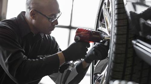 Service Technician working on a vehicle wheel