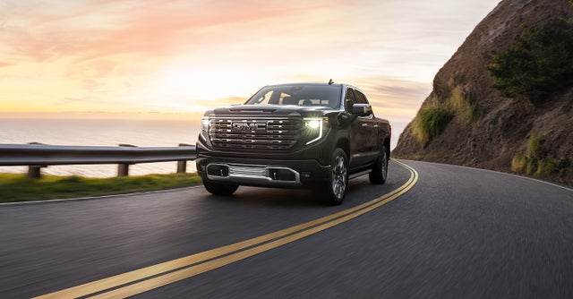 2024 GMC Sierra 1500 driving along a coastal road