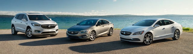 Three Buick Avenir models arranged on a beach