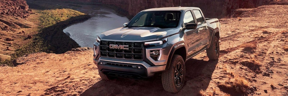 2025 GMC Canyon Truck Parked in the a rugged landscape near a winding river