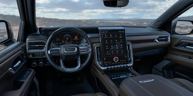 Drivers Side View of the Steering Wheel, Infotainment System and Dashboard in the GMC Yukon Denali